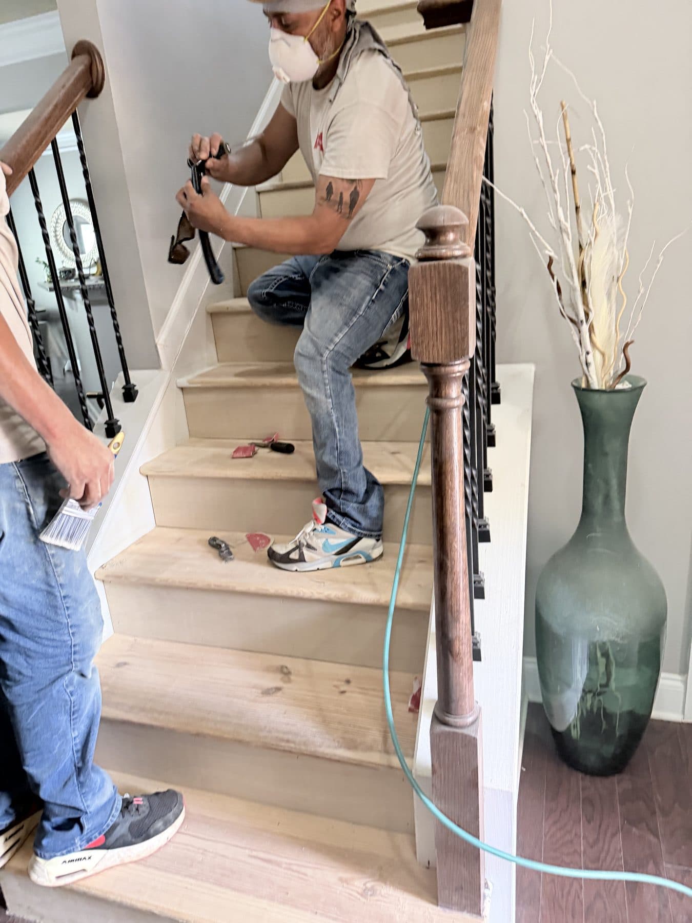 Crew member installing a staircase railing