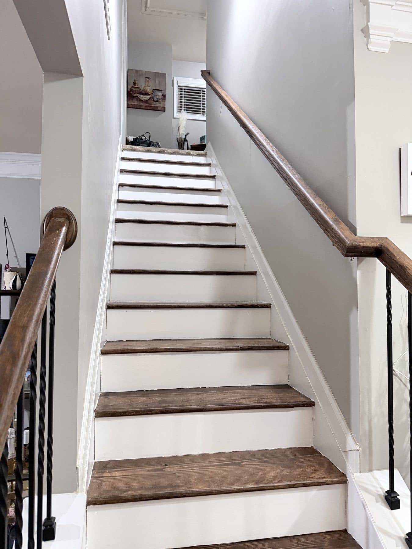 Finished staircase with iron railing