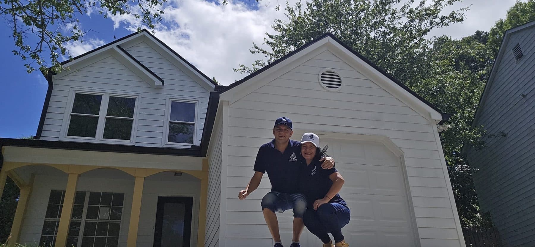 The Hand of Life Renovations team in front of a completed project